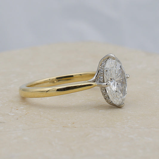 Oval diamond engagement ring with hidden halo